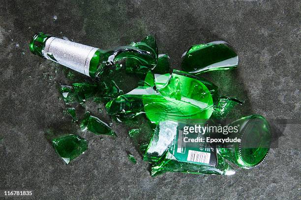 a smashed beer bottle - glass shatter stock-fotos und bilder