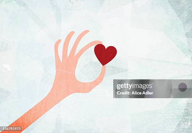 a hand holding a heart - alice by heart stock illustrations