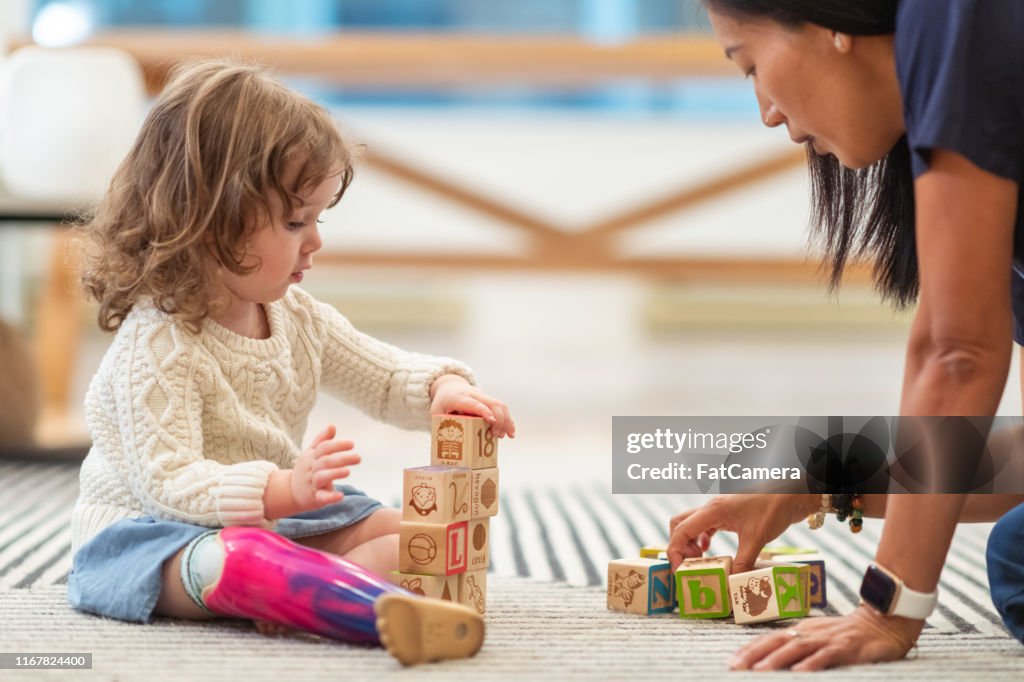 Little girl with prosthetic leg at occupational therapy appointment