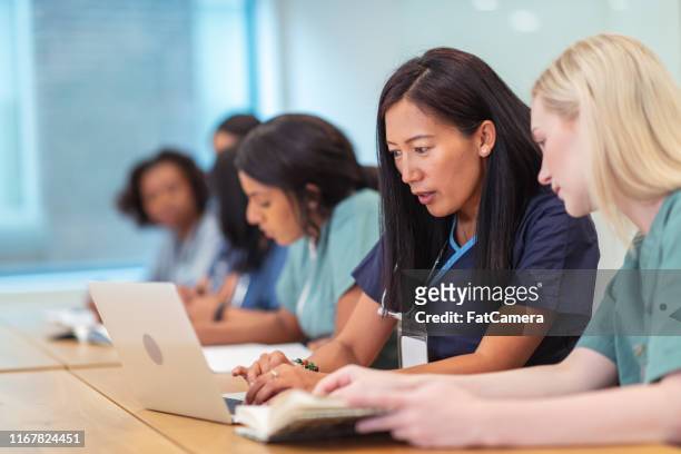 multi-ethnic group of nursing students in class - nurse education stock pictures, royalty-free photos & images