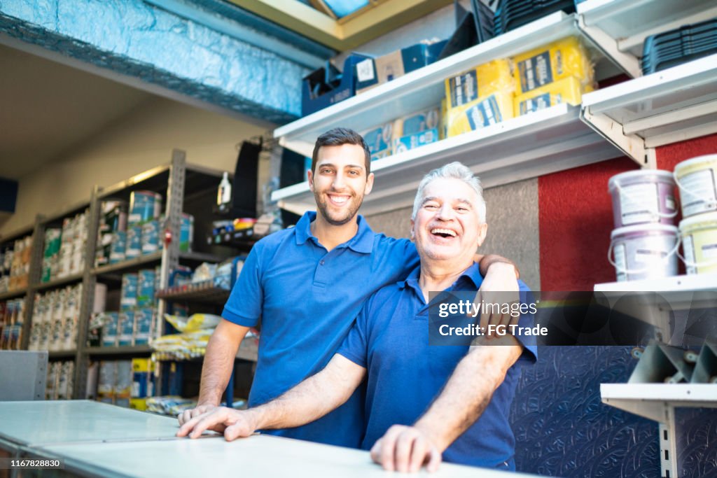 Father and son working together in a paint store