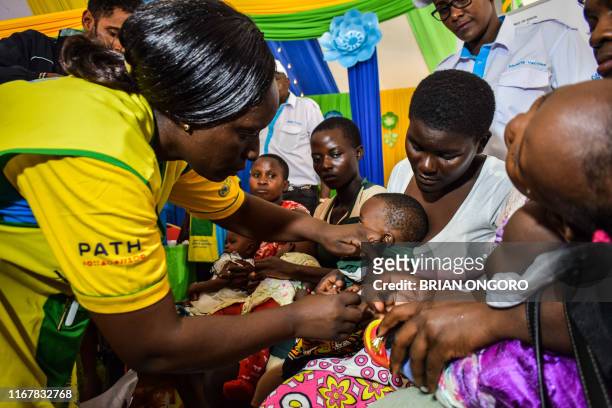 Health worker vaccinates a child against malaria in Ndhiwa, Homabay County, western Kenya on September 13, 2019 during the launch of malaria vaccine...