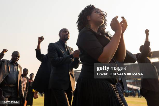 Bona Mugabe Chikore, daughter of late former Zimbabwean president Robert Mugabe, salutes the crowd gathered for viewing the body of Robert Mugabe who...