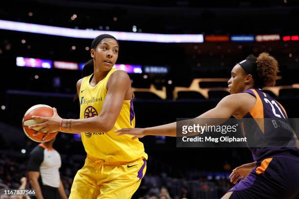Forward Candace Parker of the Los Angeles Sparks looks to pass defended by forward Brianna Turner of the Phoenix Mercury at Staples Center on August...