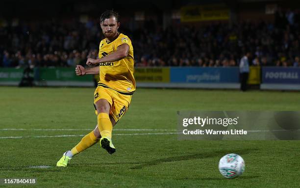 Alex Gilbey of MK Dons scores the winning penalty during the Carabao Cup First Round match between AFC Wimbledon and Milton Keynes at The Cherry Red...