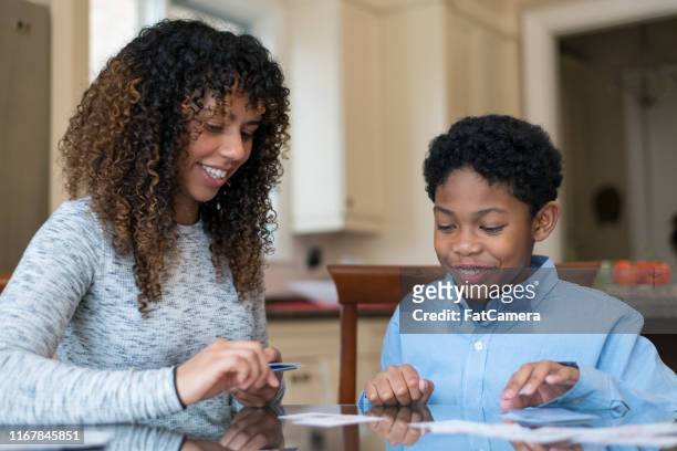 mother and son of african descent working on homework together - flash card stock pictures, royalty-free photos & images