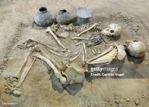 til death do us part: ancient archaeological excavation couple of human skeletons and pottery in iran - archaeological remains stock pictures, royalty-free photos & images