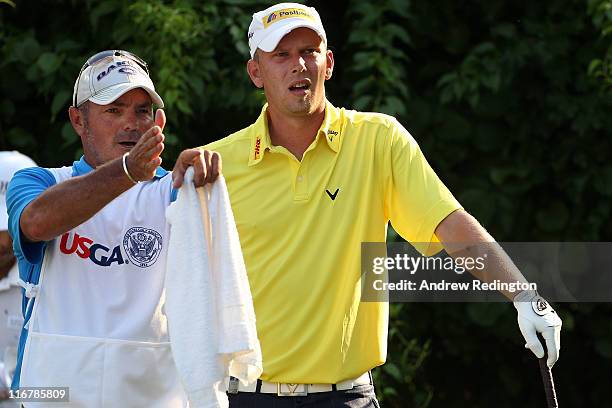 Marcel Siem of Germany talks with his caddie Kyle Roadley on the 18th tee during the second round of the 111th U.S. Open at Congressional Country...