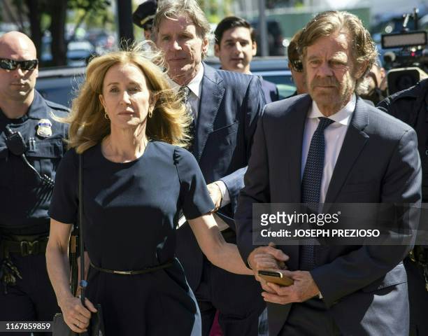 Actress Felicity Huffman, escorted by her husband William H. Macy, makes her way to the entrance of the John Joseph Moakley United States Courthouse...