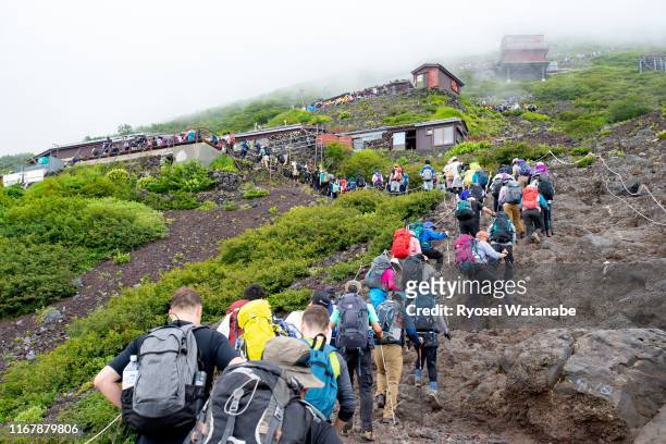 crowded mountain trail in mt. fuji - mt fuji stock pictures, royalty-free photos & images