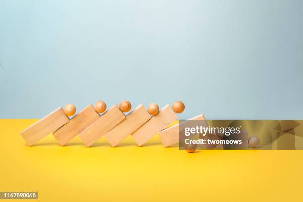 domino effect concept still life. - dominos falling stock pictures, royalty-free photos & images