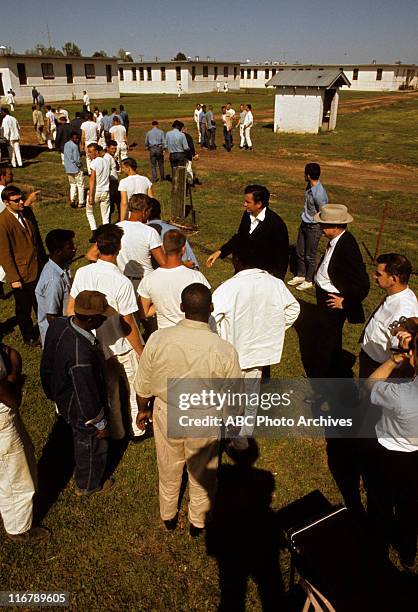 On Location at Cummins Prison Farm, Arkansas - Shoot Date: April 10, 1969. JOHNNY CASH SHAKING HANDS WITH INMATES