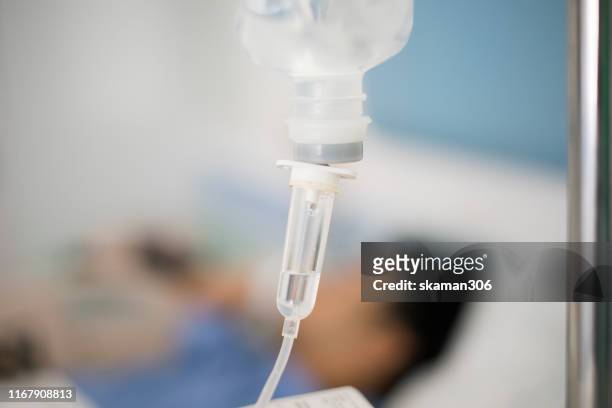 close up hand and brine - child hospital bed stockfoto's en -beelden