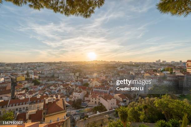sunset and night view of lisbon city from miradouro da graca - graca church stock pictures, royalty-free photos & images