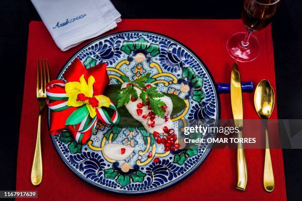 View of a dish of "Chile en Nogada" at Mexican chef Ricardo Munoz Zurita's Azul Condesa restaurant in Mexico City on September 5, 2019. - Chefs and...