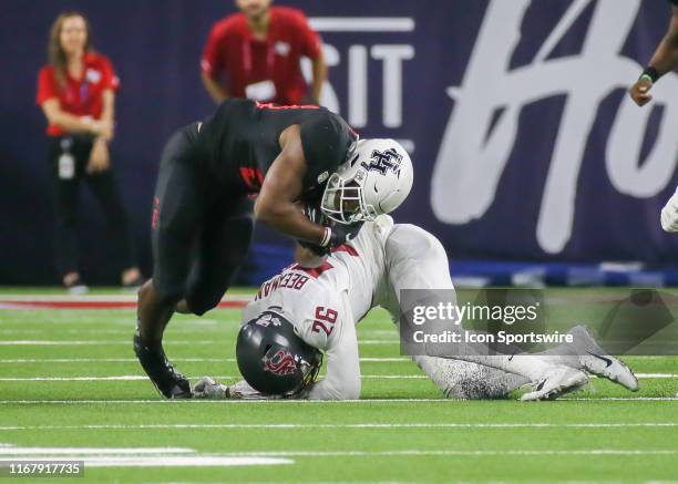 Washington State Cougars safety Bryce Beekman tackles Houston Cougars running back Kyle Porter during the AdvoCare Kickoff college football game...