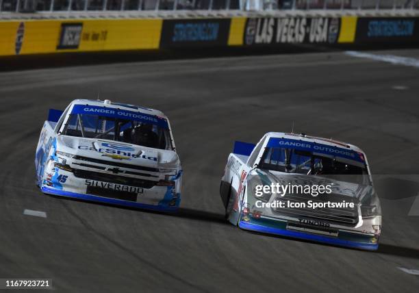 Austin Hill Hattori Racing Enterprises Toyota Tundra passes Ross Chastain Niece Motorsports Chevrolet Silverado for the lead late in the race during...