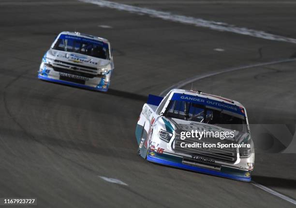 Austin Hill Hattori Racing Enterprises Toyota Tundra leads Ross Chastain Niece Motorsports Chevrolet Silverado late in the race during the NASCAR...