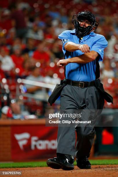 Umpire Tom Hallion calls strike three during a game between the St. Louis Cardinals and the Milwaukee Brewers in the ninth inning at Busch Stadium on...