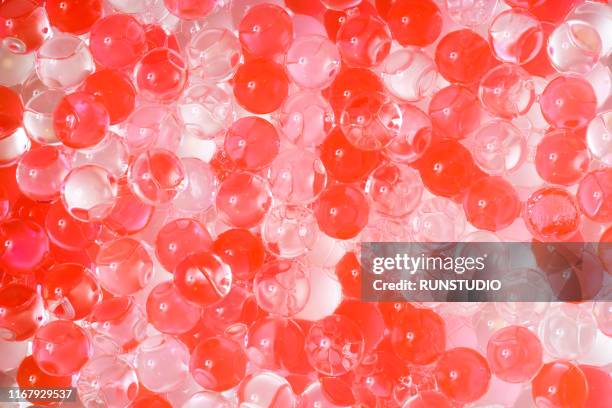 red gel spheres background - silicaat stockfoto's en -beelden