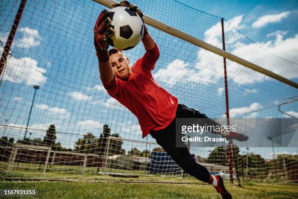 successful teenager goalkeeper - boy playing soccer stock pictures, royalty-free photos & images