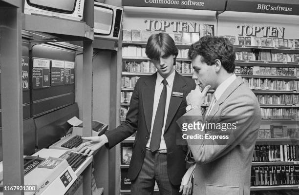 WHSmith employee helping a costumer in the home computers section at a store, UK, 10th October 1984.