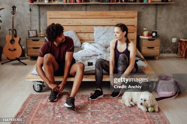 couple tying shoes - woman home run stock pictures, royalty-free photos & images