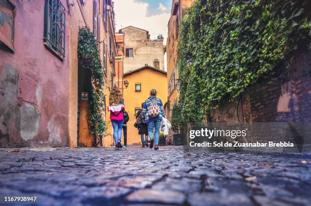 three generation family visiting rome, italy - cobblestone stock pictures, royalty-free photos & images