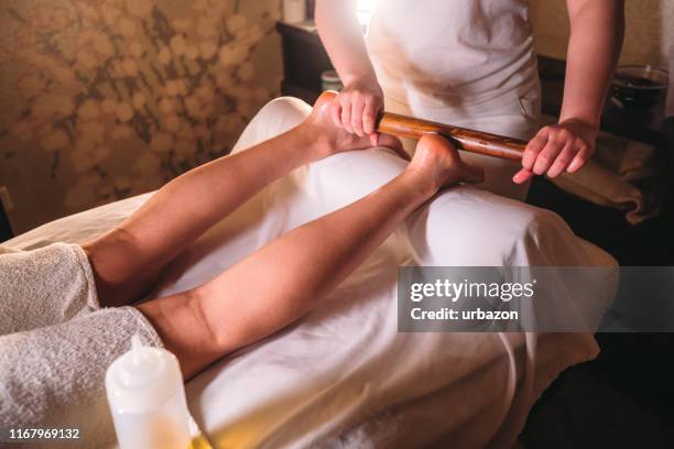 having a leg massage - woman lying on stomach with feet up stock pictures, royalty-free photos & images
