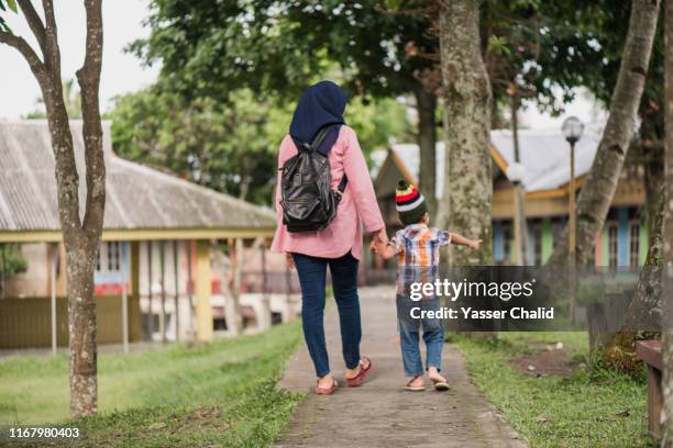 walking side by side rear view - hijab woman from behind stock pictures, royalty-free photos & images