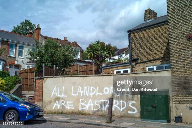 Graffiti reading 'All Landlords are Bastards' on a wall in Catford on July 07, 2019 in London, England.