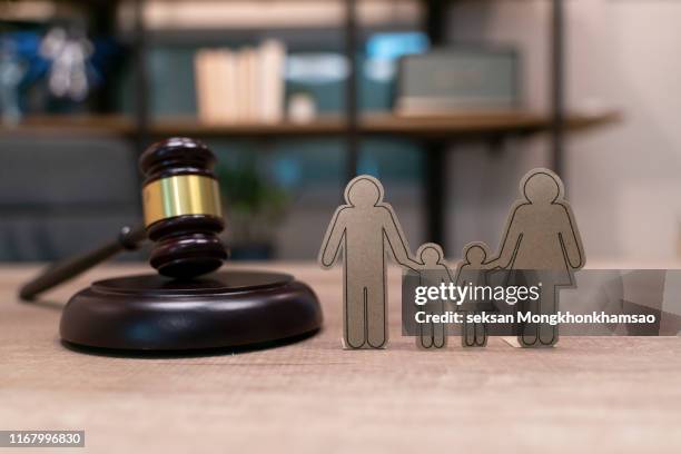 paper people chain, books and judge's gavel. law, family politics and marriage legalization. - adoption fotografías e imágenes de stock