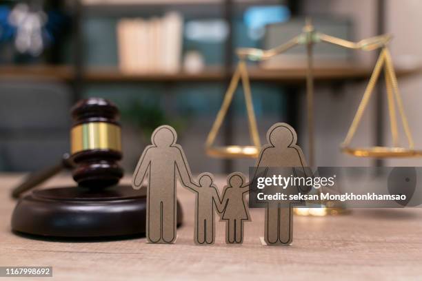 family law, family right concept. child-custody concept. family with children cutout near court gavel - regels stockfoto's en -beelden