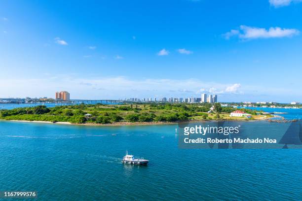 urban skyline during a vibrant blue color day, palm beach, florida, usa - palm beach florida stock pictures, royalty-free photos & images