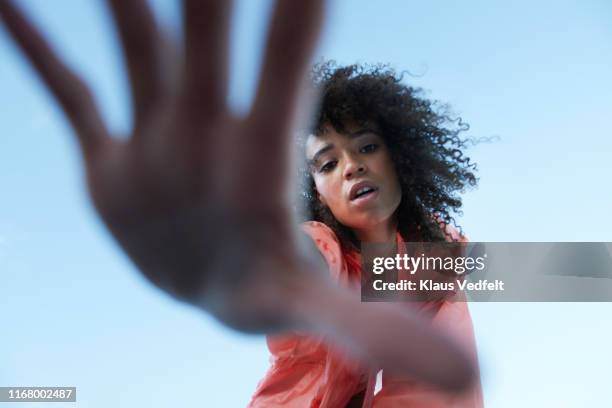 directly below portrait of sportswoman gesturing against clear sky - hand on hip bildbanksfoton och bilder