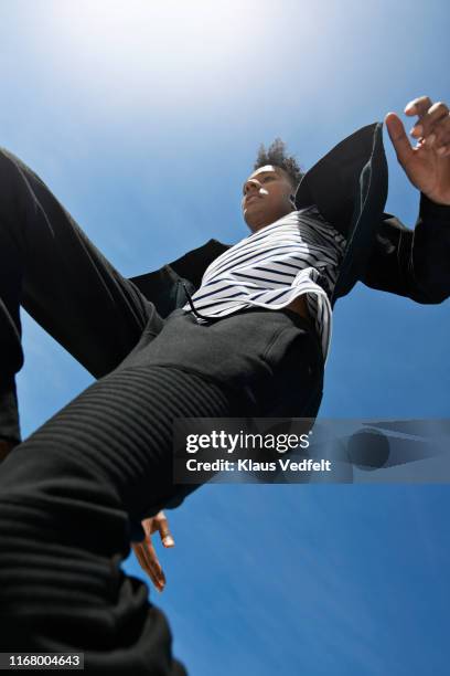 young man running against blue sky - fashion man single casual shirt imagens e fotografias de stock