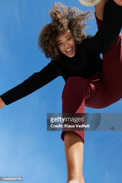 portrait of happy young woman against blue sky - hip hopper stock pictures, royalty-free photos & images
