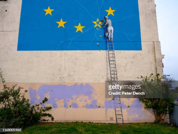 Banksy mural showing a star being chiselled from the EU flag greets visitor on April 7, 2019 in Dover,England. The booze cruise to Calais is making a...