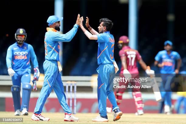 Yuzvendra Chahal and Virat Kohli of India celebrate the wicket of Evin Lewis of the West Indies during the third MyTeam11 ODI between the West Indies...