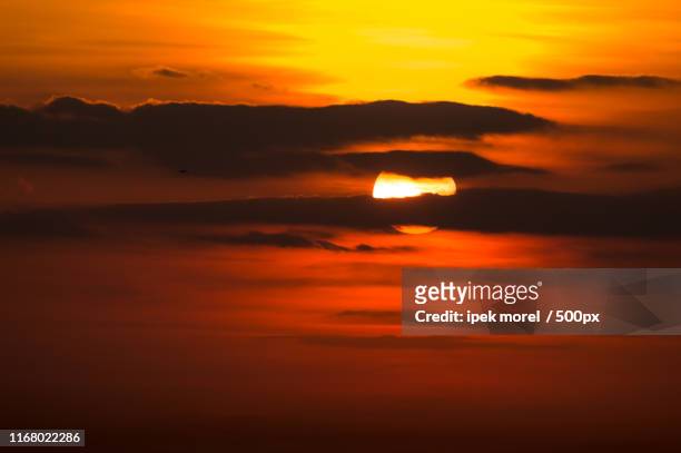 dramatic sunset in burning sky with clouds - ipek morel stock pictures, royalty-free photos & images