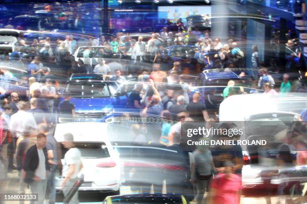 Visitors crowd around cars at the booth of German car maker Volkswagen during the Frankfurt motor show IAA 2019, in Frankfurt am Main Germany, on...