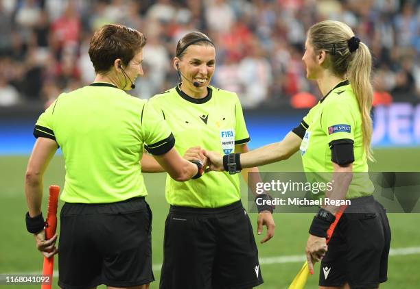 Referee Stephanie Frappart shakes hands with assistant referees Manuela Nicolosi and Michelle O'Neill prior to the UEFA Super Cup match between...