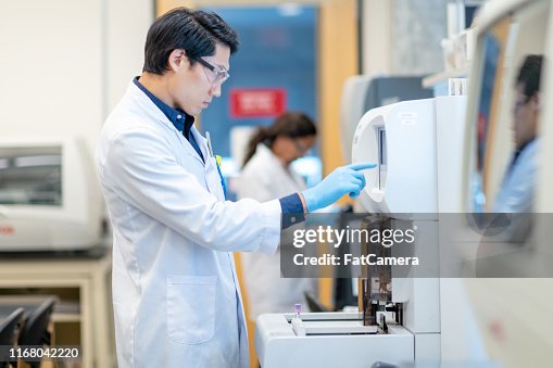 Medical Lab Tech Loading Machine Male Lab Technician Loading Medical Sample In Machine For Analysis High ...