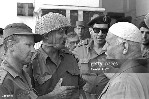 General Rehavam Zeevi , Defense Minister Moshe Dayan and General Uzi Narkiss meet with the Palestinian keeper of the Cave of the Patriarchs in the...