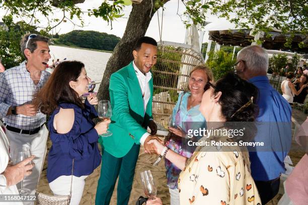 John Legend does a meet and greet backstage at a celebration of Costa Brazil and performance by John Legend at the Surf Lodge on July 14, 2019 in...