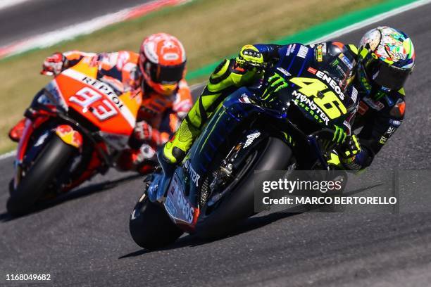 Monster Energy Yamaha Italian rider, Valentino Rossi and Repsol Honda Team Spanish rider, Marc Marquez steer their motorbikes during the Q2...