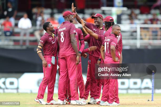 West Indies celebrate the wicket of Shikhar Dhawan during the third MyTeam11 ODI between the West Indies and India at the Queen's Park Oval on August...