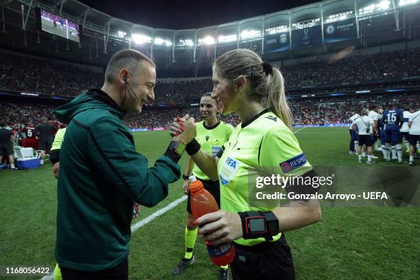 Fourth official Cuneyt Cakır shakes hands with assistant referee Manuela Nicolosi prior to extra time being played during the UEFA Super Cup match...