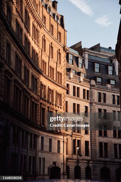 sunlight on old buildings on city street - old alleyway stock pictures, royalty-free photos & images