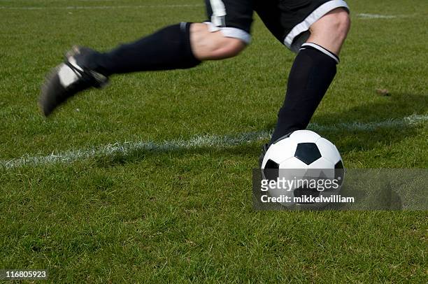 soccer player kicks a football - passing - sport stock pictures, royalty-free photos & images